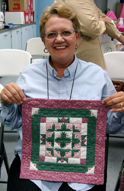 Log Cabin Garden Mini quilt and maker